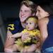 Michigan linebacker Jake Ryan poses for a photo with five-month-old Gabrielle Szemites and her mother Gabrielle, both from Fenton, during youth day at Michigan Stadium on Sunday, August 11, 2013. Melanie Maxwell | AnnArbor.com